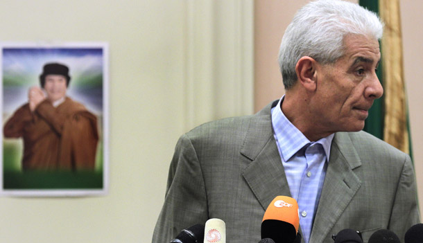 Libya's Foreign Minister Moussa Koussa reads a statement declaring a ceasefire on military operations to foreign journalists at a hotel in in Tripoli on March 18, 2011. The statement came shortly after a UN Security Council Resolution that allows the broad use of force to protect civilians on the ground in Libya. (AP/Jerome Delay)