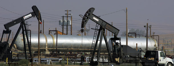 Oil well pump jacks of Chevron Corp. are shown in the hills of Coalinga, California. We must shrink oil use by increasing vehicle efficiency, using cleaner fuels, and investing in public transit. (AP/Gary Kazanjian)