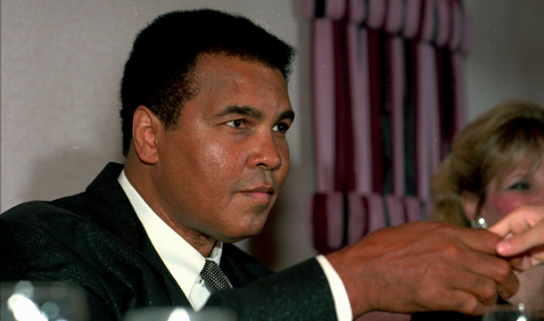 Muhammad Ali shakes the hand of a youngster during a dinner in the former champ's honor at the Ramada Inn in Lewiston, Maine, Friday, September 22, 1995. (AP/Carl D. Walsh)