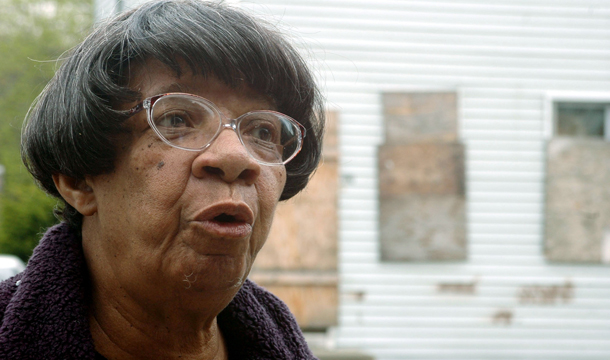 Lula Williams, a neighborhood activist, stands near her home located near an industrial area in Camden, New Jersey. Communities of color face elevated health risks because they tend to live in areas where they are disproportionately exposed to high pollution levels. (AP/Sabina Louise Pierce)