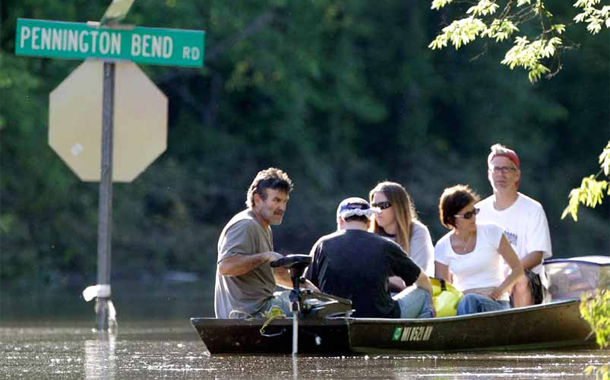 Scott Burton, left, gives a boat ride to neighbors down a flooded street Wednesday, May 5, 2010, in Nashville, Tennessee. (AP/Mark Humphrey)