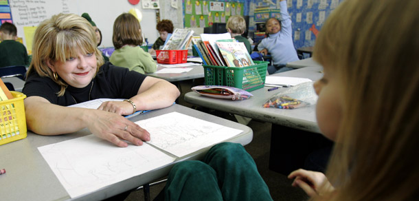 A teacher helps a student with a math problem while teaching a first-grade class at Bear Exploration Magnet School, in Montgomery, Alabama. (AP/Rob Carr)