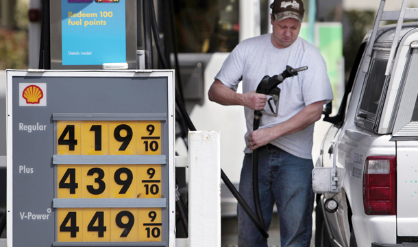 Ryan Riemath starts to fill his tank at a Shell gas station Tuesday, April 26, 2011, in the Seattle suburb of Bellevue, Washington. (AP/Elaine Thompson)
