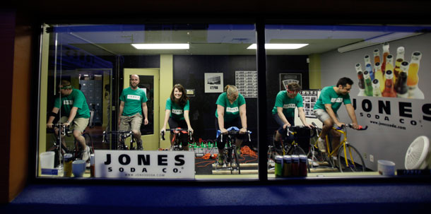 To mark Earth Day, Jones Soda Co. reduced its electrical needs for the day so that about 10 riders on bikes attached to generators can provide power all day for the beverage-maker's operations. (AP/Ted S. Warren)