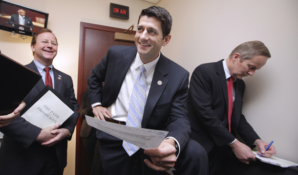 House Budget Committee Chairman Paul Ryan (R-WI), center, flanked by committee members Rep. Tom McClintock (R-CA), right, and Rep. Bill Flores (R-TX), works on Capitol Hill in Washington, Tuesday, April 5, 2011. (AP/J. Scott Applewhite)