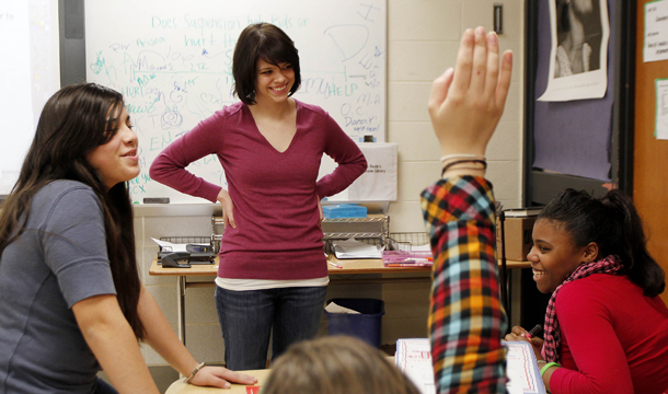 Erin Gavin, a Teach for America teacher, listens to students at a Brooklyn Center School in Brooklyn Center, Minnesota. Education has already taken a hit in this year’s budget battle as an earlier continuing resolution cut almost $750 million from the Department of Education, including cuts to Teach for America along with the Striving Readers and Even Start literacy programs and small learning communities. (AP/Andy King)