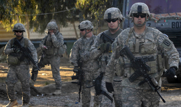 U.S. soldiers walk in Kandahar, south of Kabul, Afghanistan, on Monday, February 7, 2011. President Barack Obama has pledged to begin withdrawing American troops this July and have them completely out of Afghanistan by 2014, when the Afghans say they will be ready to take control. (AP/Allauddin Khan)