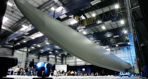 A wind turbine blade is unveiled during the opening of the Vestas blade factory in Windsor, Colorado. (AP/Jack Dempsey)