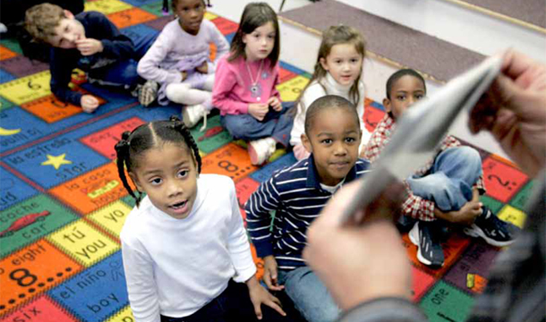 A teacher uses flash cards to teach kindergarten students during Spanish class at the charter school Oakhurst Elementary in Decatur, Georgia. (AP/John Amis)