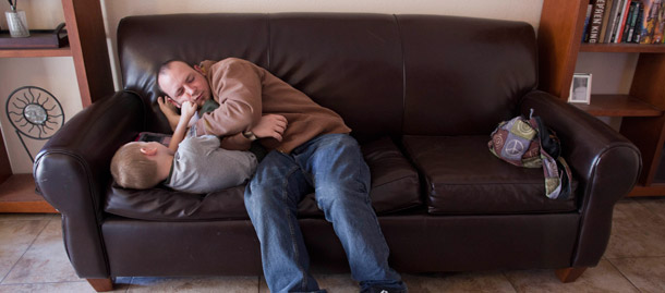 John Clark, right, who is unemployed, plays with his son Logan Burban, 5, at their home in Las Vegas. In 2010, the share of married couples with the husband unemployed rose to 3.7 percent, much higher than the share with the wife unemployed, which reached 3.1 percent. (AP/Julie Jacobson)