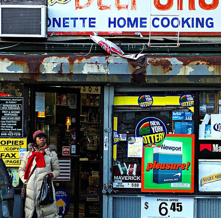 A Newport advertisement is seen on the window of a convenience store in Brooklyn, New York. Predatory marketing by tobacco companies to youth, African Americans, and Hispanics also leads to the high prevalence of menthol smoking among these populations. (AP/Paul Sakuma)