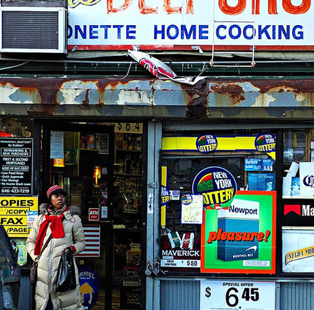 A Newport advertisement is seen on the window of a convenience store in Brooklyn, New York. Predatory marketing by tobacco companies to youth, African Americans,  and Hispanics also leads to the high prevalence of menthol smoking among  these populations. (AP/Paul Sakuma)