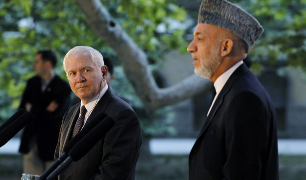 U.S. Secretary of Defense Robert Gates, left, watches as Afghan President Hamid Karzai speaks at a news conference at the Presidential Palace in Kabul, Afghanistan, Saturday, June 4, 2011. (AP/Jason Reed)
