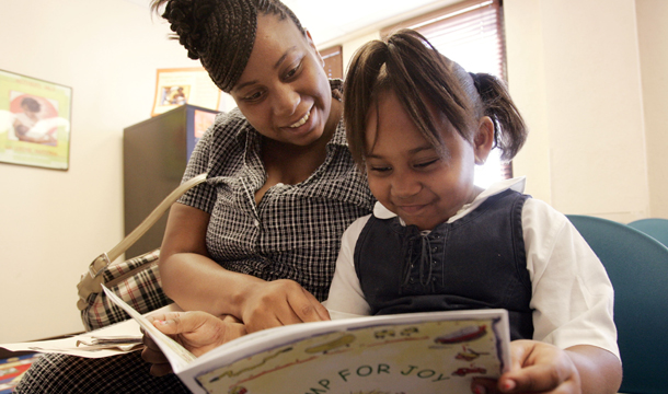 Keisty Sample and her daughter Zaria, 5, read through a nutrition booklet provided to them while attending a nutrition education class at the Dallas County WIC office in Dallas, Texas. The bill approved this week by Republicans on the House Appropriations Committee imposes deep and harmful cuts to WIC, denying assistance to 325,000 to 475,000 eligible mothers, infants, and children. (AP/Tony Gutierrez)