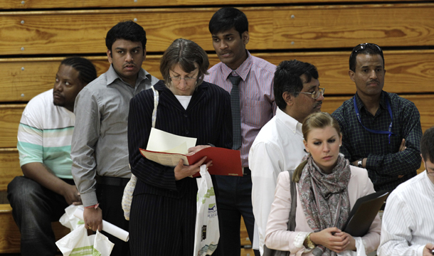 Job seekers stand in line at a job fair in Southfield, Michigan, Wednesday, June 15, 2011. There were still 6.9 million fewer jobs in May 2011 than at the start of the recession in December 2007, and the population has also grown since then, putting the labor market deeper into the hole than the raw number suggests. (AP/Paul Sancya)