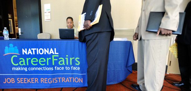 Job seekers form a line at the registration desk of a job fair in Linthicum, Maryland, on May 24, 2011. The unemployment rate is unchanged at 9.1 percent as employers added a total of only 54,000 jobs in May. (AP/Steve Ruark)