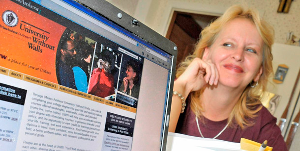 Laurel Ranticelli poses next to a University of Massachusetts website  for online classes at her home in Springfield,  Massachusetts. Online education in its emerging forms has the potential to radically change the way we deliver higher education. (AP/Lisa Poole)