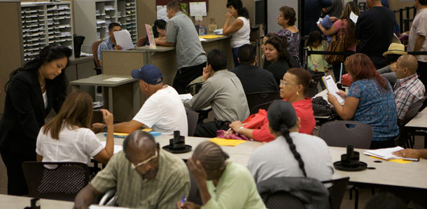 People gather at the Los Angeles County Superior Court's Resource Center for Self-represented Litigants at the Stanley Mosk Courthouse. More people are opting to represent themselves in civil court matters because they don't have the money to afford an attorney. (AP/Damian Dovarganes)