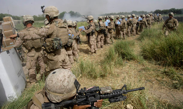 Marines unload an emergency resupply helicopter in Afghanistan. Seventy percent of convoys on the ground in Afghanistan and Iraq are dedicated solely to transporting fuel and water. (AP/David Guttenfelder)