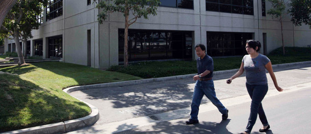 Pedestrians pass by a building at the private, for-profit Westwood College, in Torrance, California. High dropout and student loan default rates in many for-profit college career programs spurred today's gainful employment rule. (AP/Nick Ut)