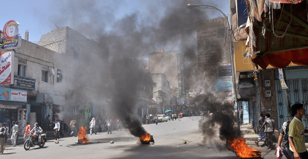 Burning tires left by antigovernment protestors as they block the road during clashes with Yemeni security forces in Taiz, Yemen. (AP/Yemen Lens)