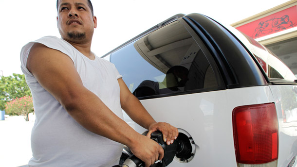 Pablo Zuniga of Dallas pumps gasoline into his vehicle at an Exxon gas  station on June 30, 2011, in Farmers Branch, Texas. Exxon posted a $10.7 billion second-quarter profit that was largely attributable to high gas prices. (AP/Tony Gutierrez)