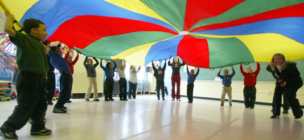 Students play under a parachute in gym class. (AP/Mary Altaffer)