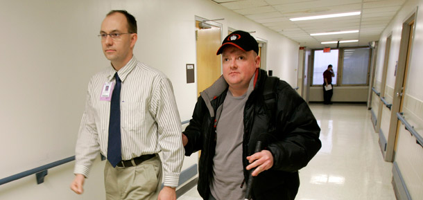 A blind veteran is assisted by a rehab specialist as  he leaves the Veterans Administration hospital in Kansas City, Missouri. Veterans health care as well as education, training, and employment for the high numbers of veterans out of work would be put at risk if the debt limit isn't raised. (AP/Charlie Riedel)