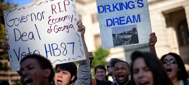 Jason Azurmendi, left, is joined by Will Pesante, center, and Kristen  Everett, right, all of Atlanta, as they protest a proposed controversial state immigration bill outside the state capitol on April 14, 2011 in  Atlanta. As most states wrap up their legislative session for the year, only a  handful (Alabama, Georgia, Indiana, and South Carolina) passed  anti-immigrant bills, while 26 others rejected them, mainly because of their cost. (AP/David Goldman)