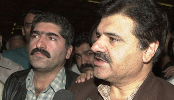 Abdul Hameed Kasi, right, and Mir Wais Kasi, brothers of Aimal Kasi, talk to journalists at Karachi Airport upon their arrival from New York on November 18, 2002. Aimal Kasi was convicted of killing two CIA employees in U.S. criminal court and executed. Conservatives are concerned that prosecuting terrorists in criminal courts poses security risks. (AP/Shakeel Adil)