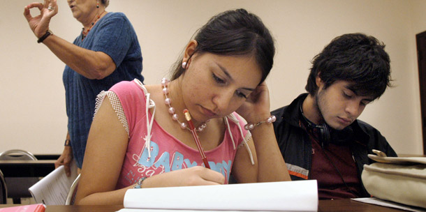 University of Texas-Southmost College students, Jessica Vargas, center,  and Patrick Flores, right, work on a writing assignment. The Pell grant program, which helps low-income students with college costs, is on the budget chopping block after years of rising costs. (AP/Brad Doherty)