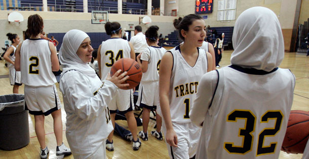 Fordson High School basketball player Fatima Kobeissi, left and teammate Hyatt Bakri wait before the basketball game against Willow Run in Dearborn, Michigan. (AP/Carlos Osorio)