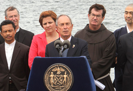 New York City Mayor Michael Bloomberg, center, City Council Speaker  Christine Quinn, and local religious leaders voice their support for a  proposed mosque near Ground Zero at a news conference on Governors  Island in New York Harbor with the Statue of Liberty in the background on August 3, 2010. (AP/Seth Wenig)