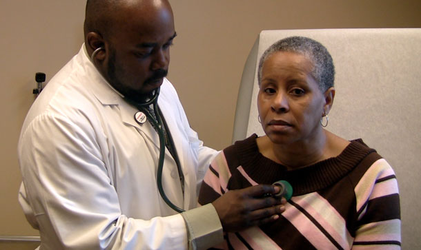 Sharron Moore is examined by Dr. Patrick Antoine at the Southside Medical Center in Atlanta. Moore began using the community health center after losing her job and insurance. (AP/Johnny Clark)