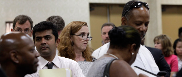 Attendees stand in lines that weave throughout a room filled with  recruiting booths during a National Career Fairs job fair in Dallas on July 13, 2011. (AP/Tony Gutierrez)