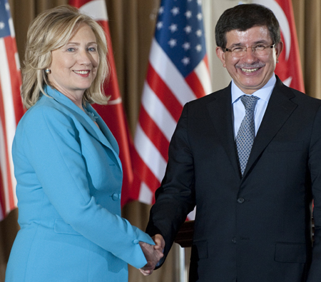 Turkish Foreign Minister Ahmet Davutoglu, right, and U.S. Secretary of State Hillary Clinton shake hands after holding a joint press conference following meetings at Sait Halim Yalisi in Istanbul, Turkey, on Saturday, July 16, 2011. (AP/Saul Loeb)
