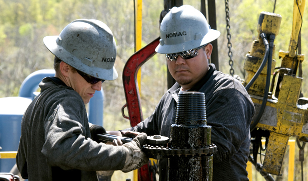 Workers move a section of well casing into place at a Chesapeake Energy natural gas well site near Burlington, Pennsylvania. A report by a shale gas subcommittee of the Secretary of Energy Advisory Board explicitly recognizes that unless the environmental concerns over hydraulic fracturing, or fracking, are addressed, the growth of the shale gas industry could be threatened. (AP/Ralph Wilson)