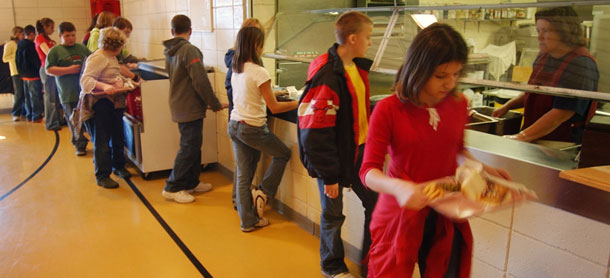 Students line up for lunch in Chetopa, Kansas. Programs that support education, infrastructure, nutritional supports for new moms and kids, transportation, and job training may be on the chopping block in upcoming deficit reduction talks. (AP/Orlin Wagner)