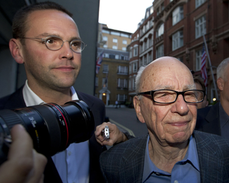News Corp. Chairman and CEO Rupert Murdoch, right, arrives at his residence in central London with his son James Murdoch, chairman and CEO of News Corp. Europe and Asia, Sunday, July 10, 2011. (AP/Sang Tan)