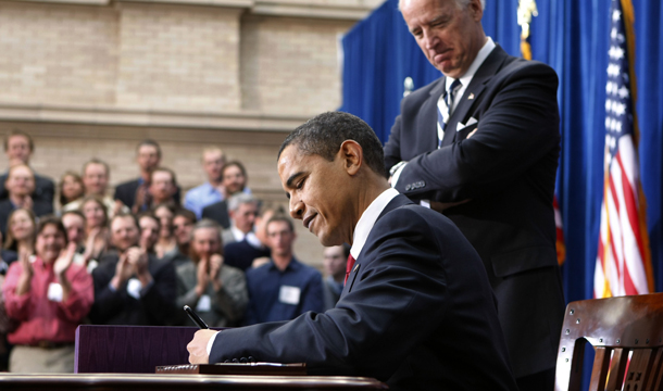 Vice President Joe Biden looks on as President Barack Obama signs the American Recovery and Reinvestment Act, Tuesday, February 17, 2009, during a ceremony at the Denver Museum of Nature and Science in Denver. (AP/Gerald Herbert)