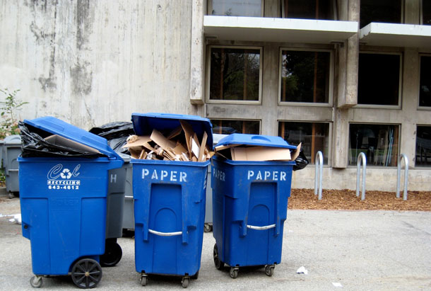 Campus recycling cans overflow with paper and cardboard. (Flickr/orphanjones)
