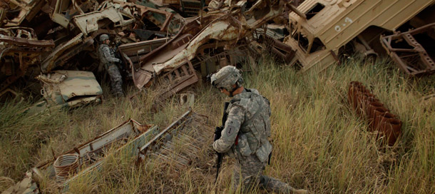 Army troops search a Saddam Hussein-era military vehicle graveyard outside Contingency Operating Site Taji, north of Baghdad, Iraq, on August 7, 2011. Seventy-three percent of Iraq and Afghanistan veterans who recently returned from combat are personally comfortable with gays and lesbians. (AP/Maya Alleruzzo)