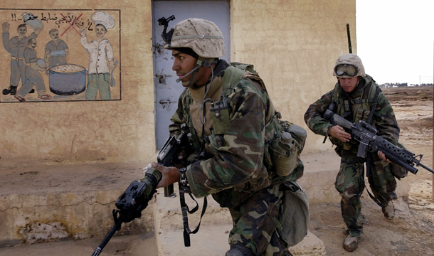 U.S. marines with India Co., 3rd Batt., 7th Marines, 1st Marine Division, secure an Iraqi army outpost and training center near the town of Numaniyah, Iraq, on Wednesday, April 2, 2003. (AP/Laura Rauch)