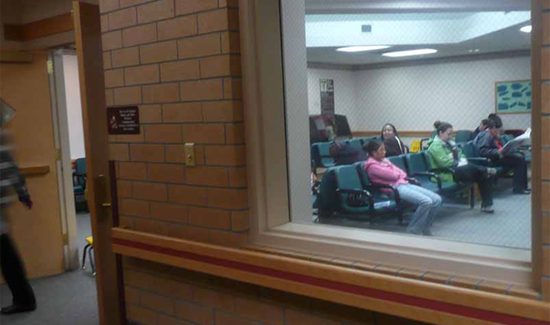 People sit in the waiting room of a clinic in Crow Agency, Montana. (AP/Mary Clare Jalonick)
