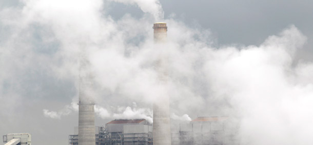 Piles of coal are shown at NRG Energy's W.A. Parish Electric Generating Station, March 16, 2011, in Thompsons, Texas. Putting a price on carbon could generate revenues that we could use to lower the deficit. (AP)