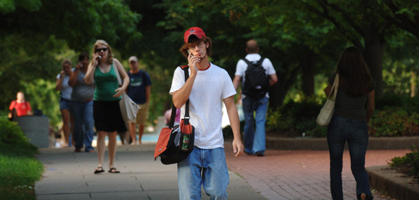 A student talks on the phone on the University of Missouri campus. The Department of Education is developing a model financial aid letter for incoming college students that aims to help them better understand their options for paying for college. (AP/L.G. Patterson)