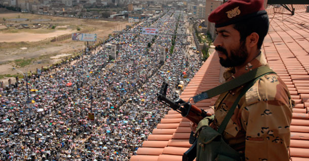 A defected soldier stands guard while protestors attend a demonstration demanding the resignation of Yemen's President Ali Abdullah Saleh in Sanaa, Yemen, Friday, September 23, 2011. The president made a surprise return to Yemen on Friday after more than three months of medical treatment in Saudi Arabia. (AP/Mohammed al-Sayaghi)