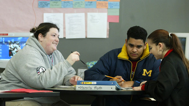 An AmeriCorps volunteer works with students. Programs such as AmeriCorps, which offers job training and education that make young adults competitive for future work, are on the chopping block in upcoming deficit reduction talks. (AP/Ted S. Warren)