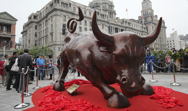 Italian-American artist Arturo Di Modica's Charging Bull statue, which is a similar version of his Wall Street Bull, is unveiled Saturday, May 15, 2010, on the Bund in Shanghai, China. (AP/Eugene Hoshiko)