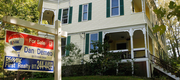 A house with a "for sale" sign in front is seen in Newton, Massachusetts. The Obama administration announced changes today to its Home Affordable Refinance Program to help more people access the program. (AP/Steven Senne)
